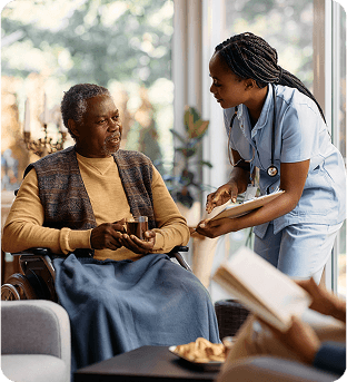 Nurse showing elderly person in a chair their medical chart