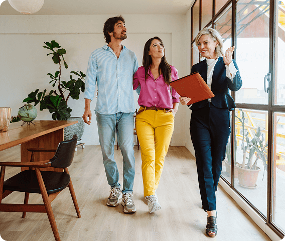 Realtor showing a young couple a modern well lit new house