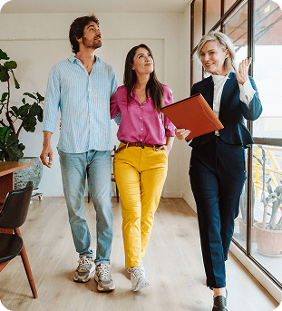 Realtor showing a young couple a modern well lit new house